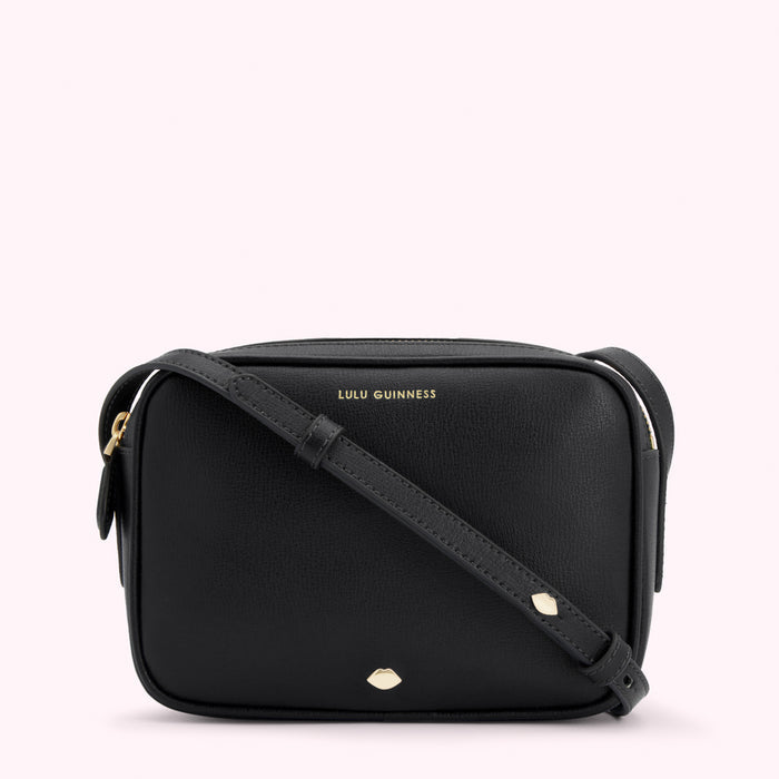 Black Lulu Guinness crossbody bag with gold logo and lip detail.