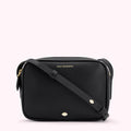 Black Lulu Guinness crossbody bag with gold logo and lip detail.