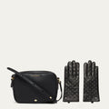 Black handbag and studded gloves on a light beige background