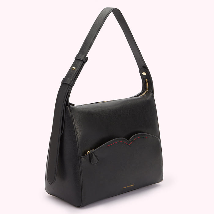 Side image of a black leather shoulder bag with front zip pocket with contrast red stitching.