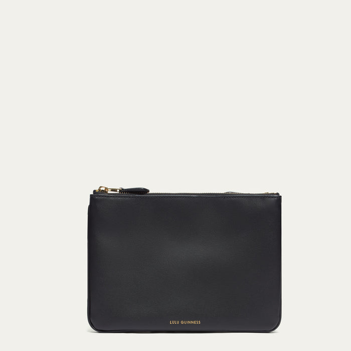 Black leather crossbody bag with gold zipper on a white background