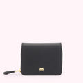 Front image of a black leather pure with gold zipper and gold metal lip pin detail.