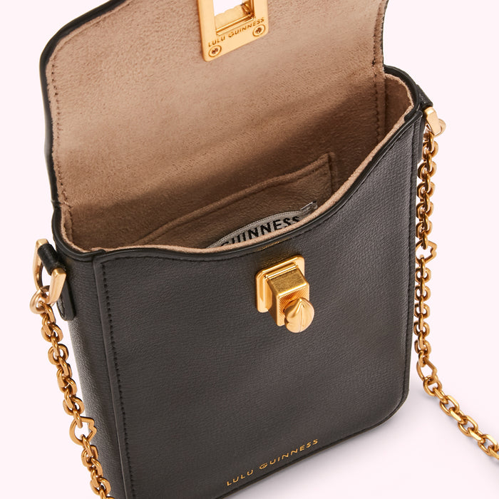 Black Lulu Guinness leather crossbody bag with gold-tone hardware and chain strap. The bag is open, showing the beige interior.