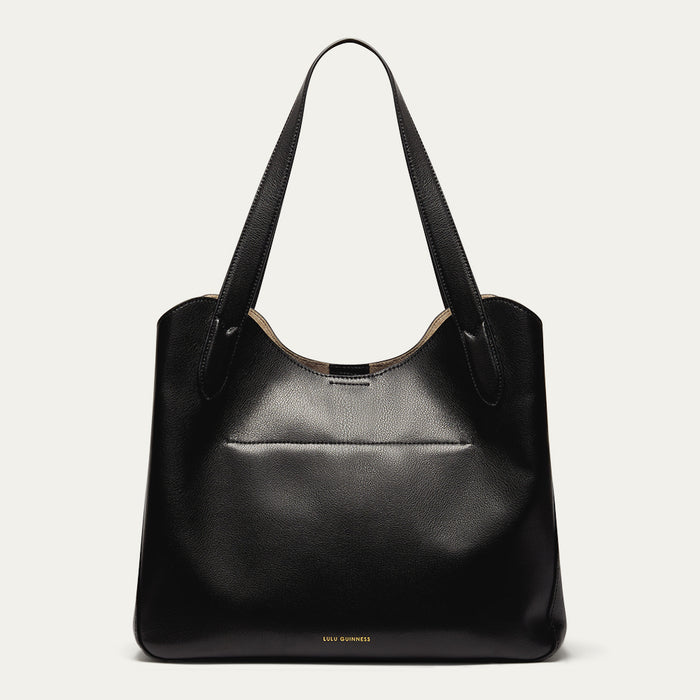 Black leather handbag on a light grey background