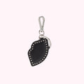 Black leather lip-shaped keychain with silver studs and metal ring.