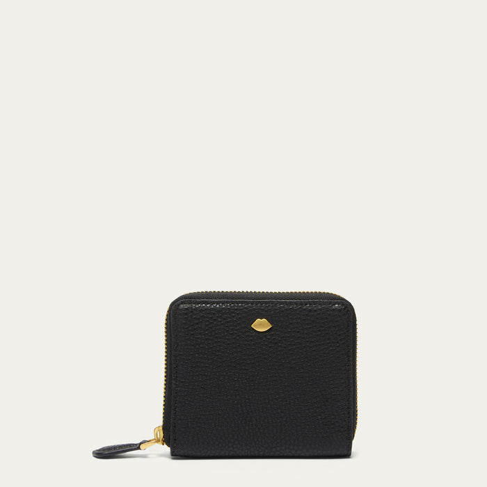 A small black pebbled leather zip-around wallet with gold-tone hardware and a small lip-shaped stud on the front, shown against a plain off-white background.