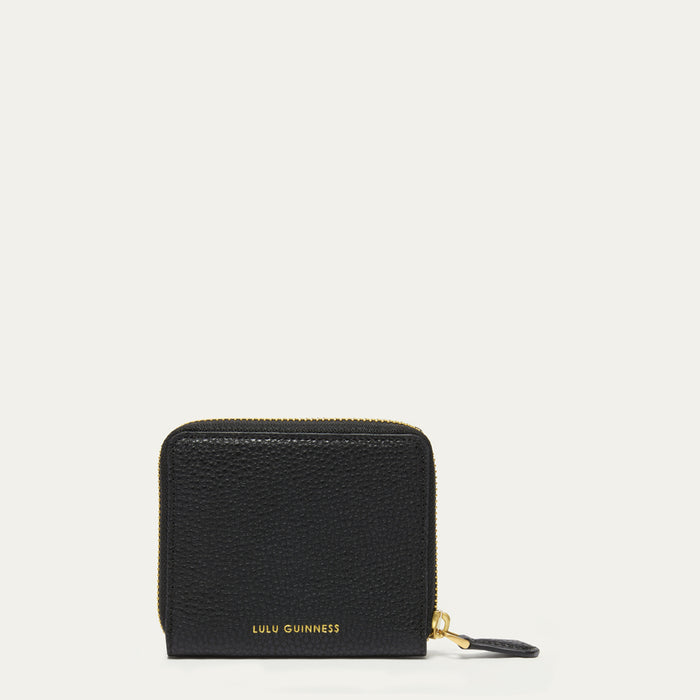 A black pebbled leather zip-around wallet by Lulu Guinness with gold-tone lettering and zipper hardware, shown on a plain off-white background.