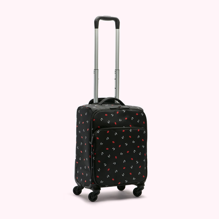 Black carry-on suitcase with red lips pattern on a white background.
