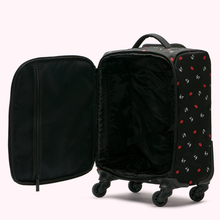 Open black carry-on suitcase with red lip print, showing interior compartments and wheels.