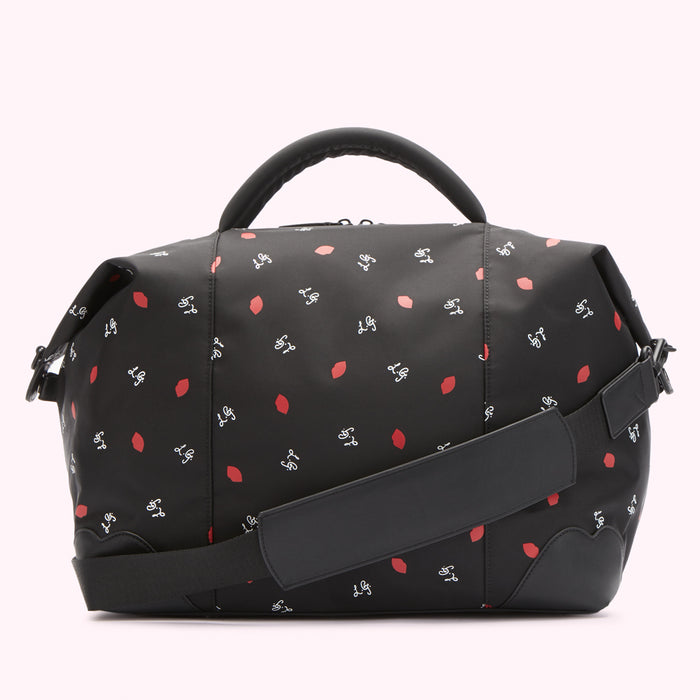 Black duffel bag with a red lips and white script logo pattern.