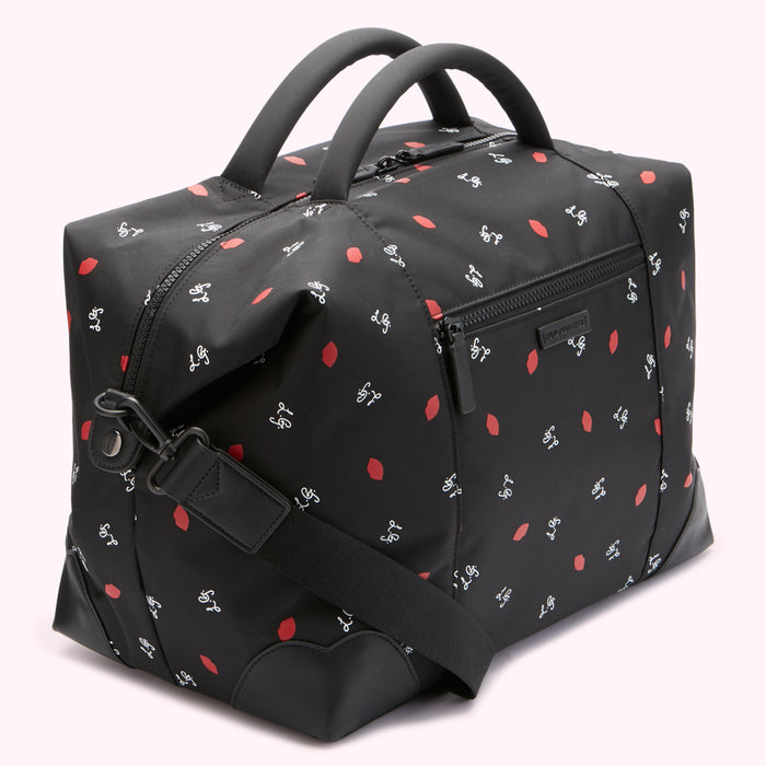 Black duffel bag with red lips and white lettering print.