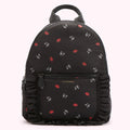 Black Lulu Guinness backpack with red lips and white L.G. logo print, and black ruffle trim.