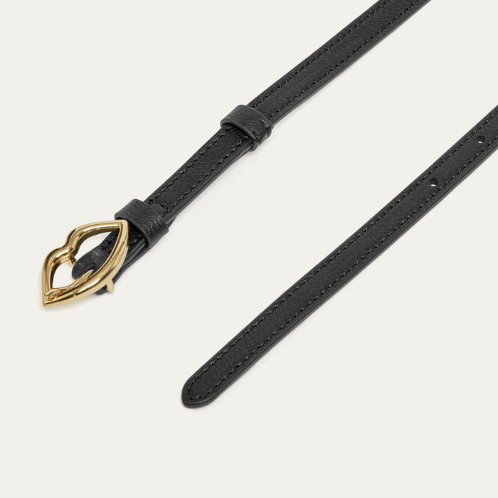 Black leather belt with gold lip-shaped buckle.