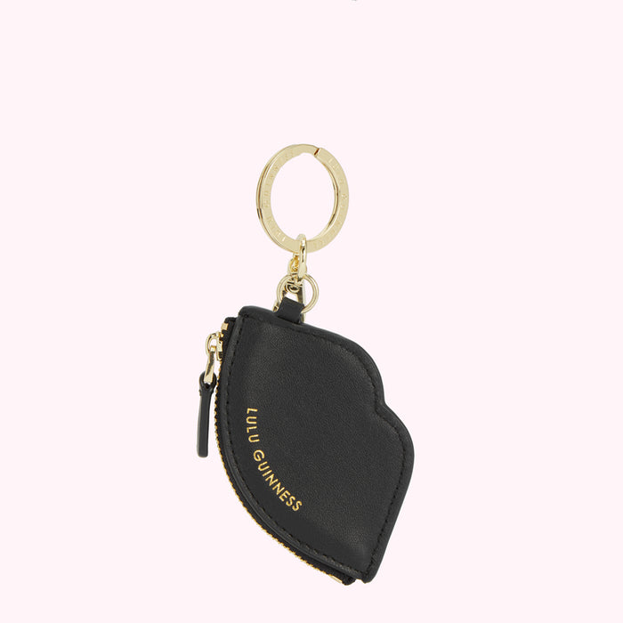 Black leather Lulu Guinness lip-shaped coin purse keychain with gold zipper and keyring.