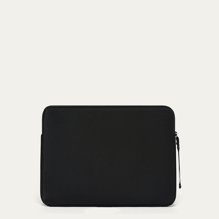 Black laptop sleeve on a light beige background
