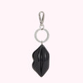 Black lip-shaped keychain with silver ring and clasp.