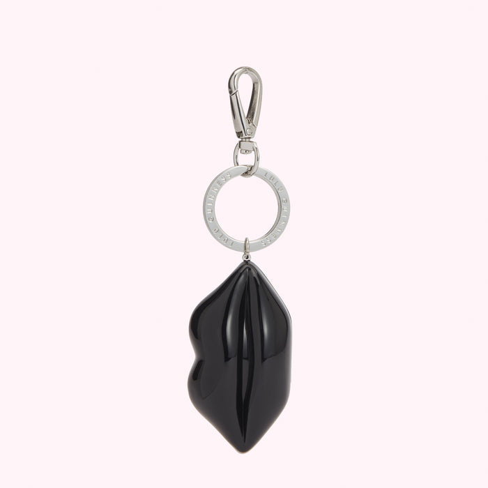 Black lip-shaped keychain with silver ring and clasp.