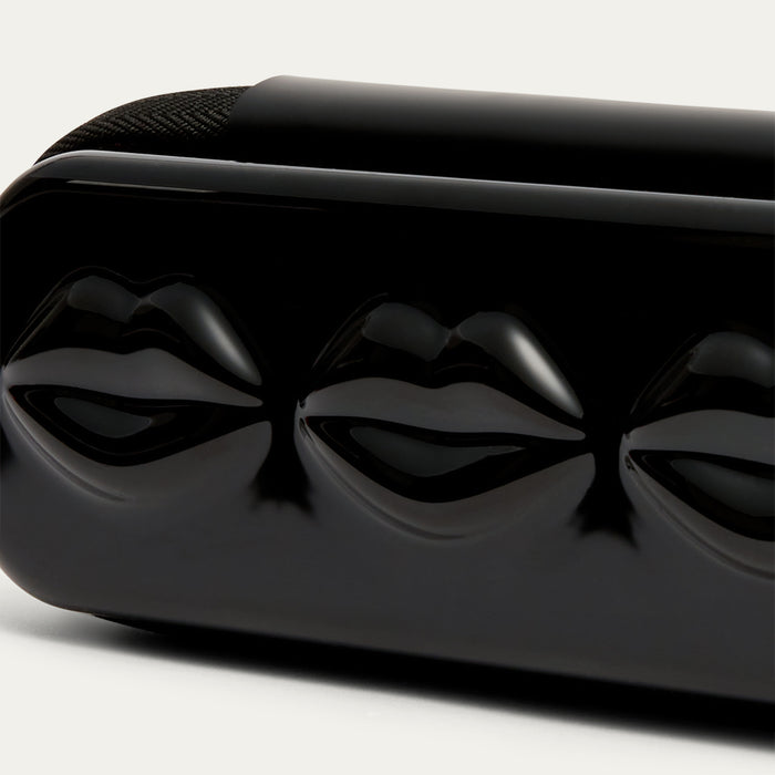 Close-up of a black sunglasses case with lip details on a white background.