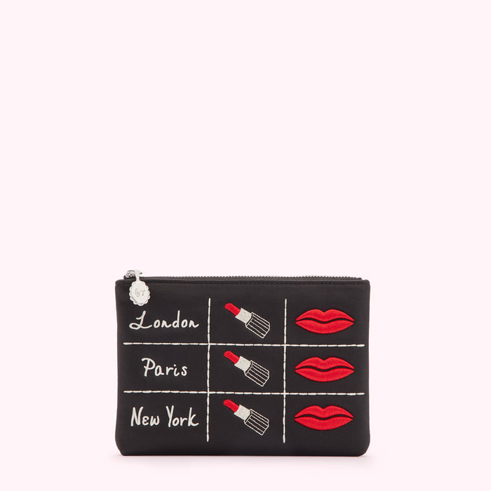 Black makeup bag with embroidered lipsticks and lips, and the words London, Paris, and New York.