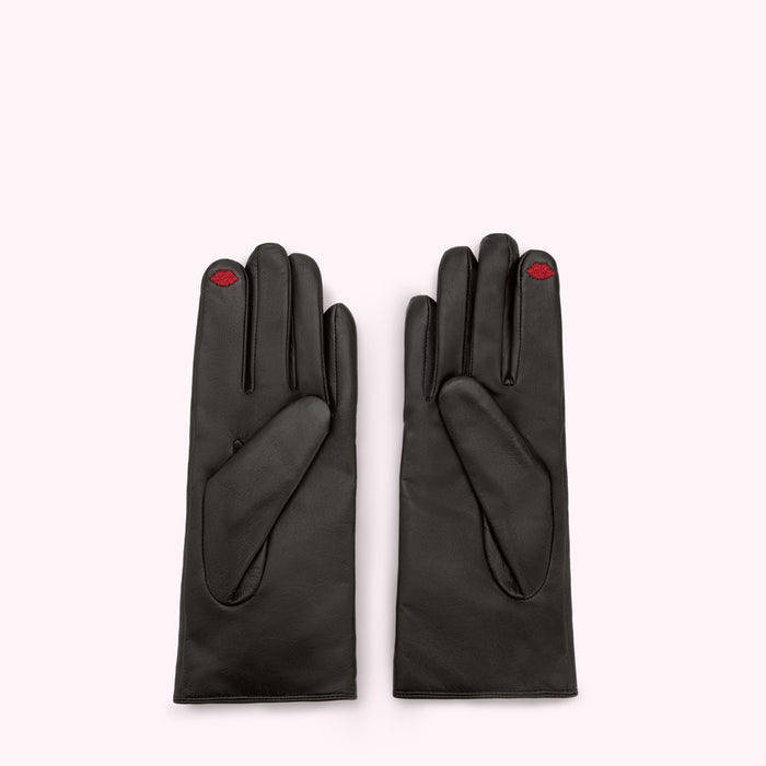 A pair of black leather gloves with a small red lip embroidered on each index finger.