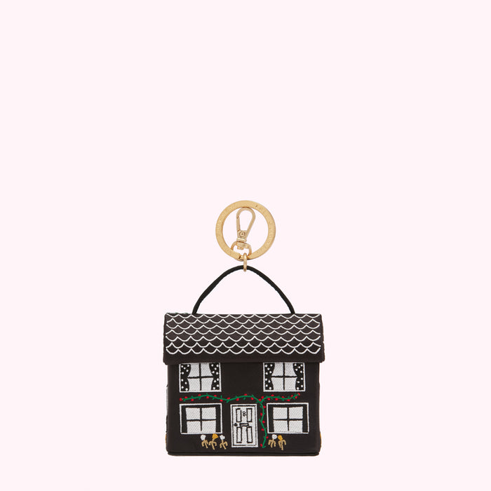 Black house-shaped keyring with white details and gold ring.