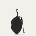 Black lip shaped charm on a light grey background