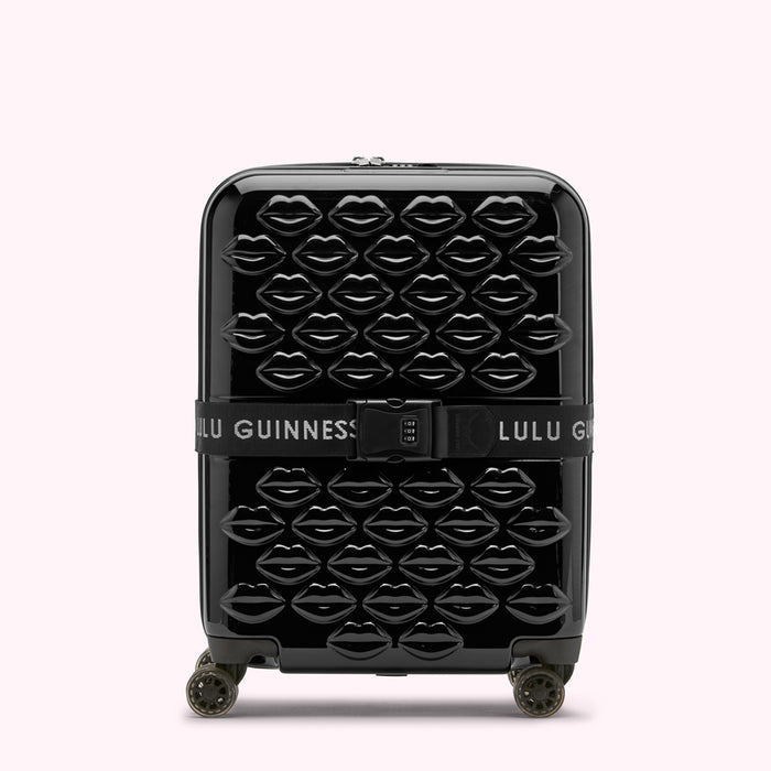 Black Lulu Guinness suitcase covered in black lips.