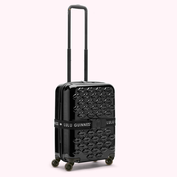 Black Lulu Guinness cabin suitcase with a lip pattern.