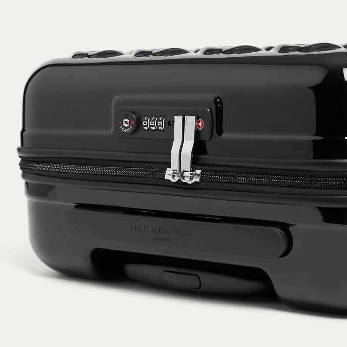 Black suitcase with visible brand logo on a white background