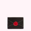 Black leather envelope-shaped cardholder with a red wax seal emblem.
