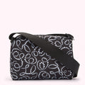 Black crossbody bag with white pearl pattern.