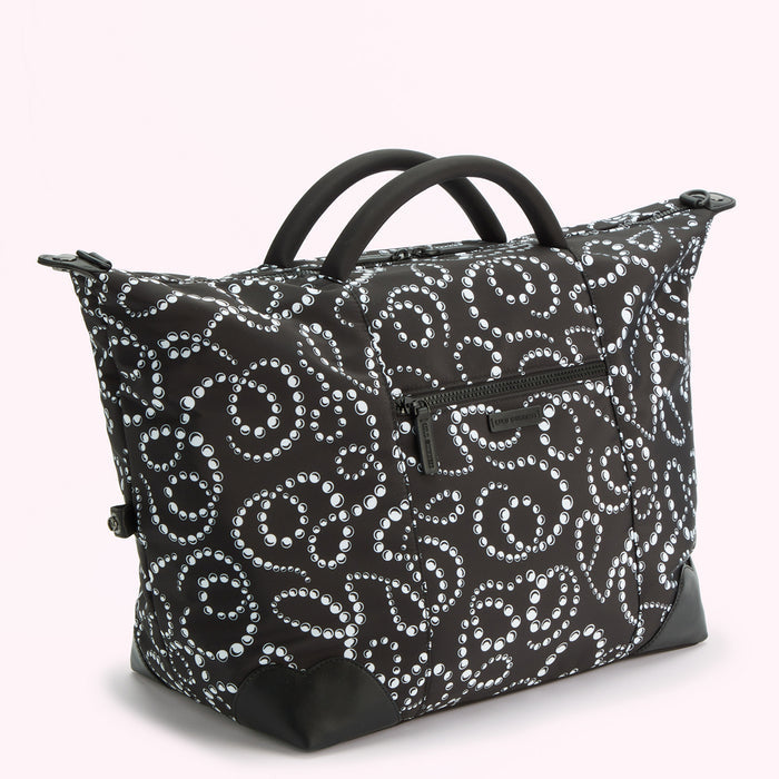 Black and white pearl pattern holdall bag with black handles.