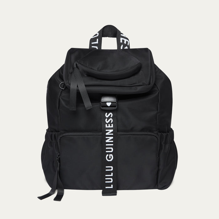 Black backpack with Lulu Guinness strap on a light grey background