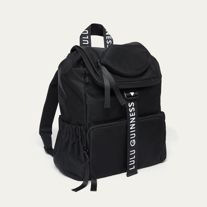 Black backpack with 'Lulu Guinness' branding on a light grey background