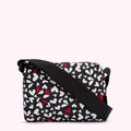 Black crossbody bag with a white and red heart pattern.