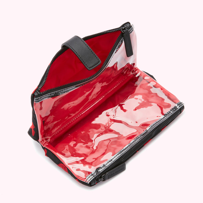 Open red and black floral print zippered travel cosmetic bag with clear compartments.