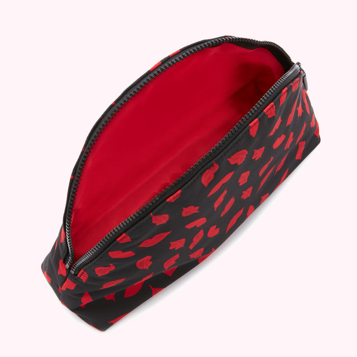 Black makeup bag with red lip print, open to reveal a red interior.