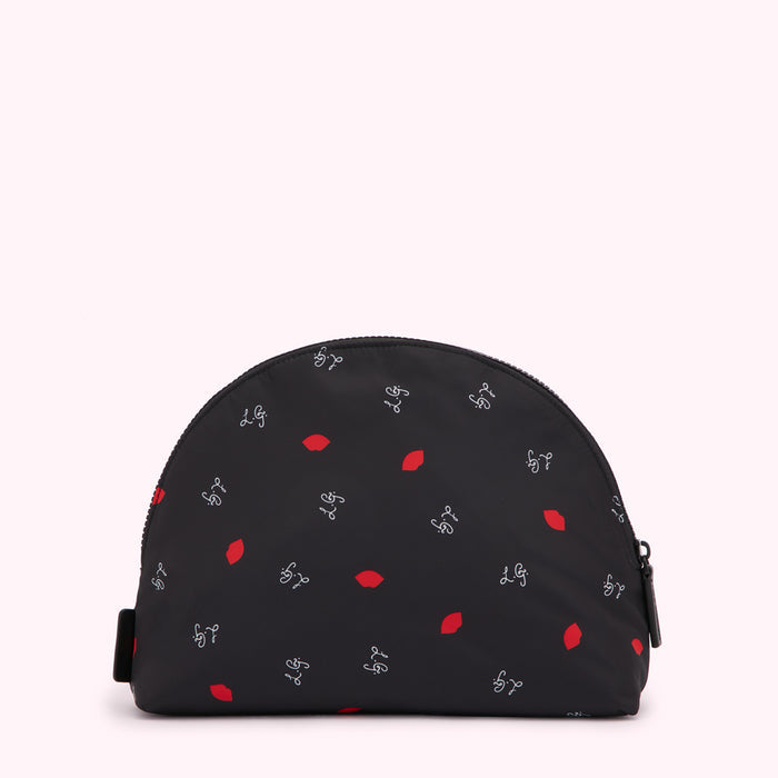 Black half-moon shaped cosmetic bag with a repeating pattern of red lips and the initials "L.G." in a script font.