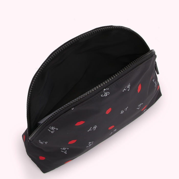 Open black makeup bag with red lips and white lettering pattern on a white background.