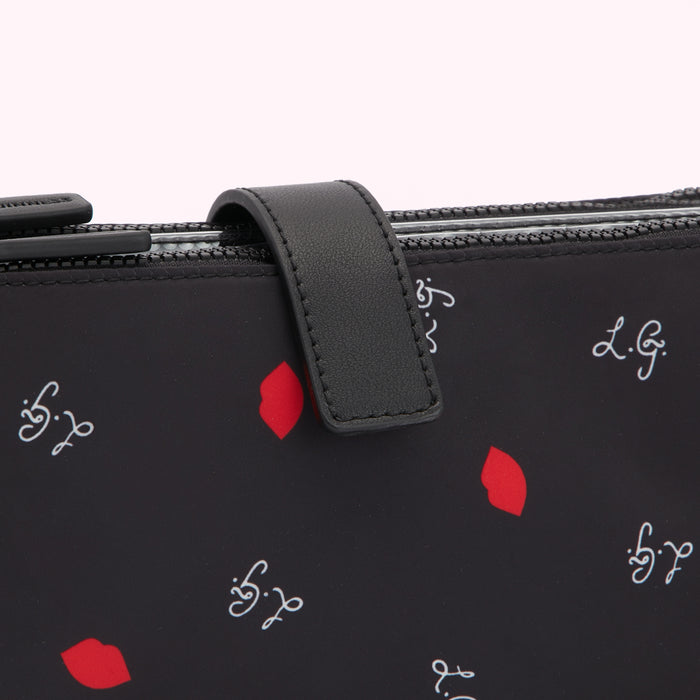 Close-up of a black wallet with red lips and white script print.