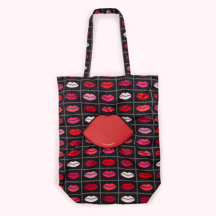 Black tote bag with red lips pattern and a red lip-shaped coin purse.