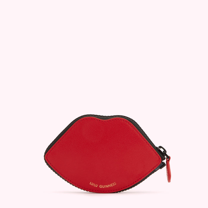 Red lip-shaped zip purse by Lulu Guinness against a white background.