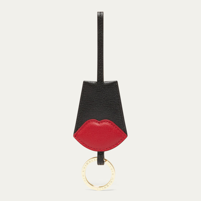 Keychain with black and red design on a light grey background
