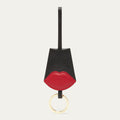 Keychain with black and red design on a light grey background