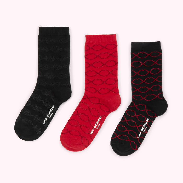 Three pairs of Lulu Guinness socks with a lip print; one pair is black, one is red, and one is black and red.