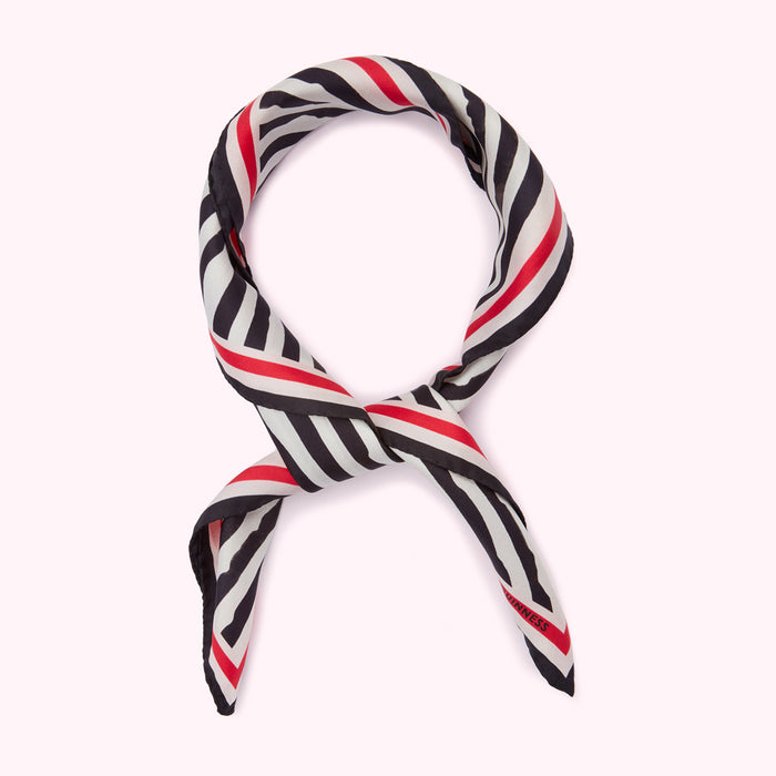 Black and white striped silk scarf with red stripes, knotted.