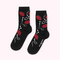 Pair of black socks with a red lips and white dots design. The socks have the Lulu Guinness London logo on one sock.