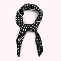 Black silk scarf with white polka dots, tied in a knot.
