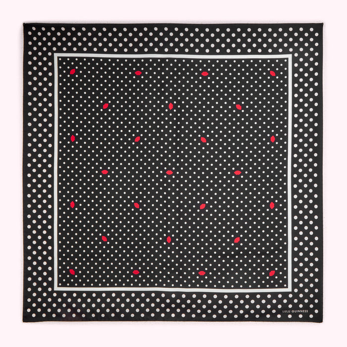 Black and white polka dot silk scarf with red lips pattern and Lulu Guinness logo.