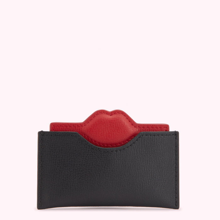 Black leather card holder with a red lip detail.